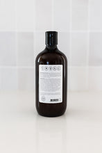 Load image into Gallery viewer, Bottle of dog shampoo with natural ingredients, sulphate and paraben free with spiced cucumber, lavender and tea-tree scent in a bathroom. Back label view.
