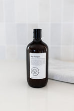 Load image into Gallery viewer, Bottle of dog shampoo with natural ingredients, sulphate and paraben free with spiced cucumber, lavender and tea-tree scent in a bathroom
