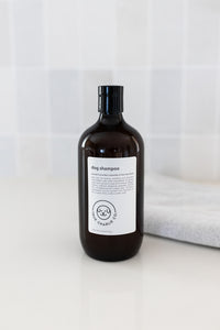 Bottle of dog shampoo with natural ingredients, sulphate and paraben free with spiced cucumber, lavender and tea-tree scent in a bathroom