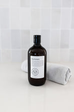 Load image into Gallery viewer, Bottle of dog shampoo with natural ingredients, sulphate and paraben free with spiced cucumber, lavender and tea-tree scent in a bathroom
