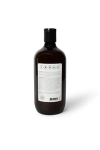 Bottle of dog shampoo with natural ingredients, sulphate and paraben free with spiced cucumber, lavender and tea-tree scent